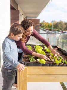mother-son-working-urban-garden-home